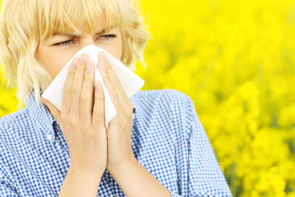 Woman with allergy over flowers